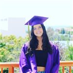 Graduate in front of building 